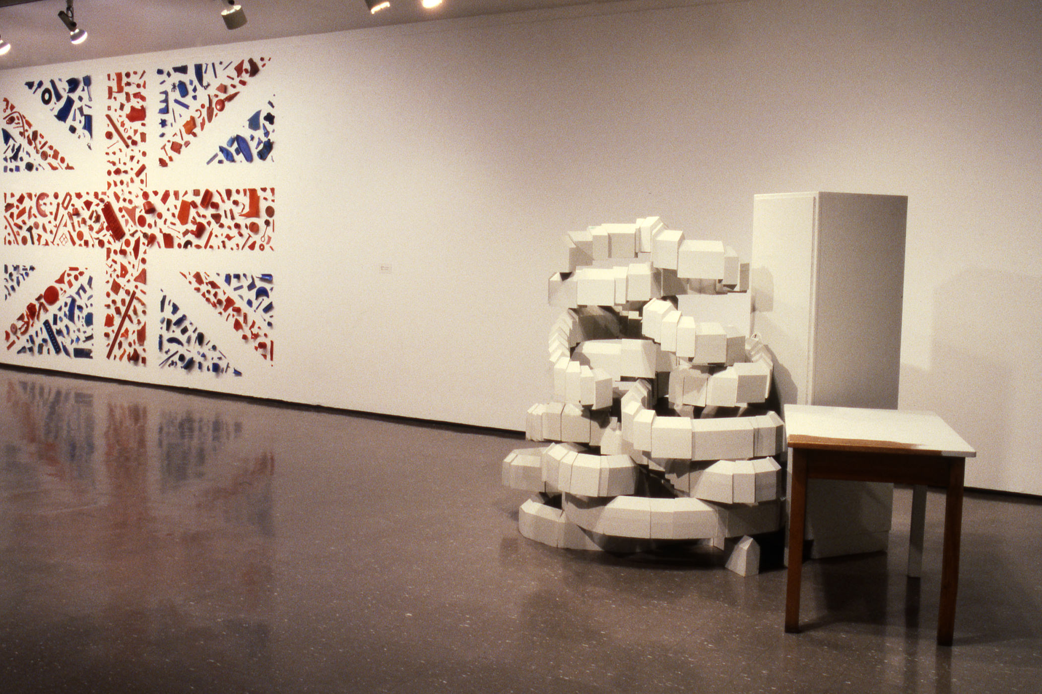  1987–88, showing, left to right: Tony Cragg, <i>Postcard Flag (Union Jack)</i>, 1981, and <i>Città</i>, 1986. Collection Museum of Contemporary Art Chicago Library and Archives