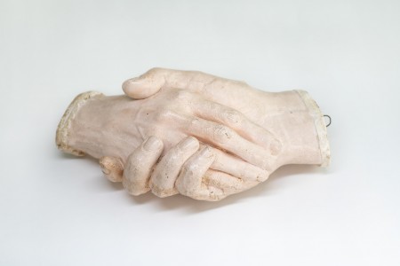 Life cast of two hands clasped together